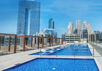 a swimming pool on the roof of a building with a city skyline at Chic Marina View - Timeless Studio Escape in Dubai