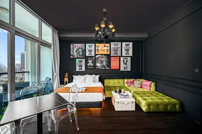 a bedroom with a bed and a green couch at Chic Marina View - Timeless Studio Escape in Dubai