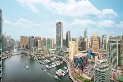 a view of a city with boats in the water at Elegant 3-Bedroom Haven - Panoramic Marina Views in Dubai
