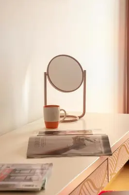 a mirror on a table with a cup and a book at Frank Porter - Rimal 1, JBR in Dubai