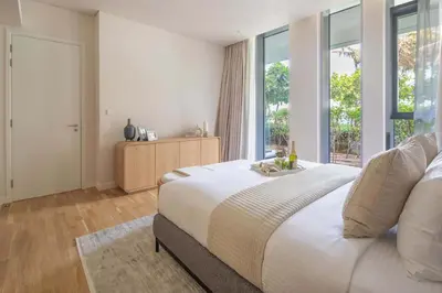 a bedroom with a large bed and a large window at Frank Porter - Bluewaters Residences 5 in Dubai