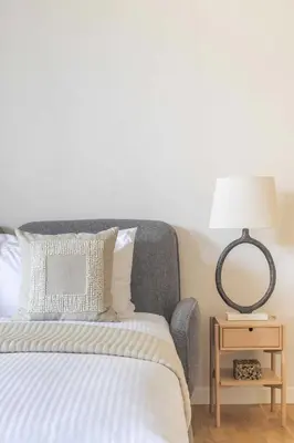 a bedroom with a bed and a table with a lamp at Frank Porter - Bluewaters Residences 5 in Dubai