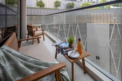 a balcony with a table and chairs on a building at Frank Porter - Dunya Tower, Downtown in Dubai