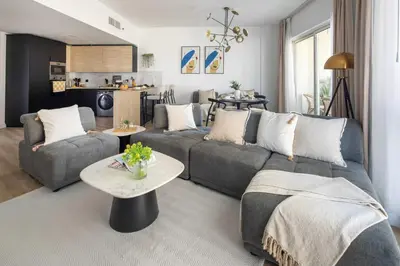 a living room with a couch and a table at Frank Porter - Lago Vista Tower A in Dubai