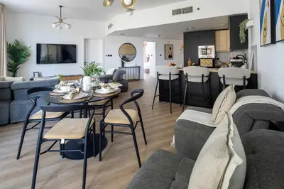 a living room with a table and chairs at Frank Porter - Lago Vista Tower A in Dubai