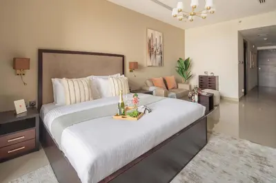 a bedroom with a large bed with a tray of food on it at Frank Porter - Dt1 Tower, Downtown Dubai in Dubai