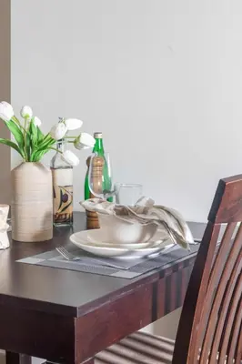 a dining room table with a plate and a chair at Frank Porter - Dt1 Tower, Downtown Dubai in Dubai