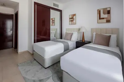 a hotel room with two beds and a mirror at Frank Porter - Elite Residence, Dubai Marina in Dubai