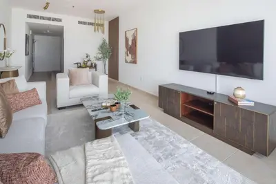 a living room with a large flat screen tv at Frank Porter - Elite Residence, Dubai Marina in Dubai