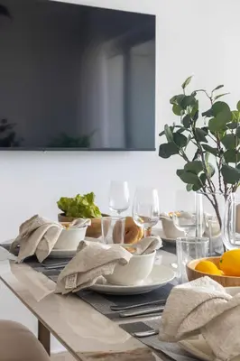 a table with plates and wine glasses on it at Frank Porter - Elite Residence, Dubai Marina in Dubai