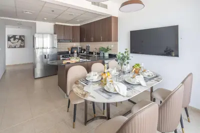a kitchen and dining room with a table and chairs at Frank Porter - Elite Residence, Dubai Marina in Dubai