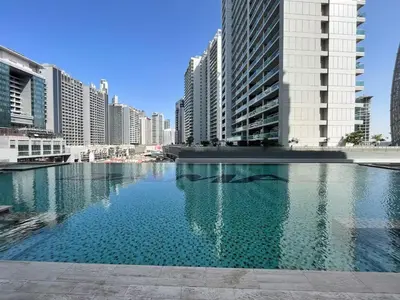 a large pool of water in a city with tall buildings at DAMAC Majestine Studio with Pool, Spa and Gym Near Bus & DubaiMall in Dubai
