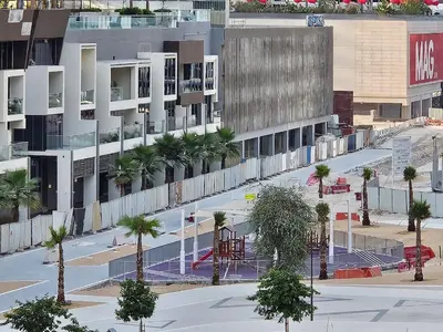 an overhead view of a city with palm trees and a building at DAMAC Majestine Studio with Pool, Spa and Gym Near Bus & DubaiMall in Dubai
