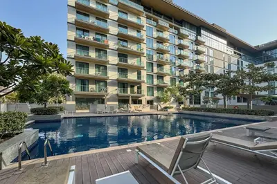 a swimming pool in front of a building at Modern and Elegant 1 Bed Retreat in Prime Location in Dubai