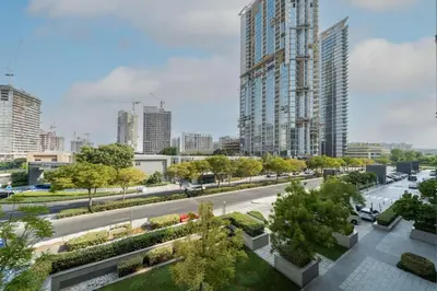 a rendering of a street in a city with tall buildings at Modern and Elegant 1 Bed Retreat in Prime Location in Dubai