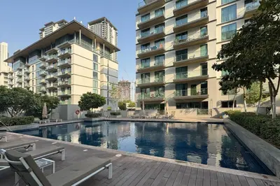 a swimming pool in front of a building at Modern and Elegant 1 Bed Retreat in Prime Location in Dubai