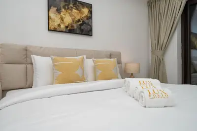 a bedroom with a white bed with pillows at Elegant Palm Living Upgraded Golden Mile 1 Bed in Dubai