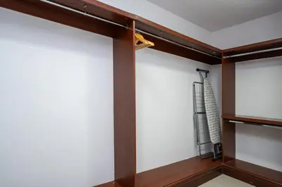 a closet with white walls and wood trim at Elegant Palm Living Upgraded Golden Mile 1 Bed in Dubai