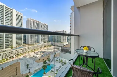 a balcony with a table and a view of a city at Nice New Studio 2 Double Beds In Downtown, Free Parking in Dubai
