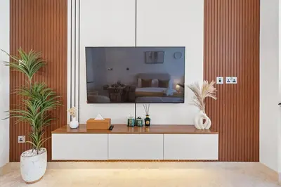 a living room with a large tv on the wall at Nice New Studio 2 Double Beds In Downtown, Free Parking in Dubai