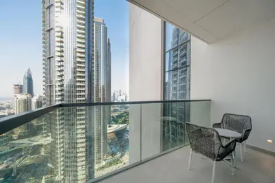 a balcony with a table and chairs in a building at Act tower 2BR, near burj khalifa in Dubai