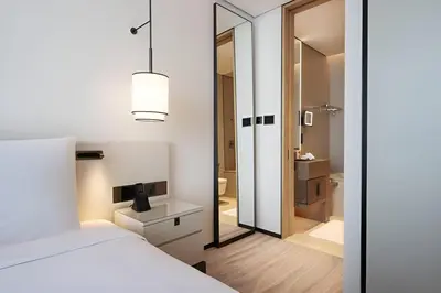 a bedroom with a white bed and a mirror at Scenic 1BR - The Address JBR in Dubai