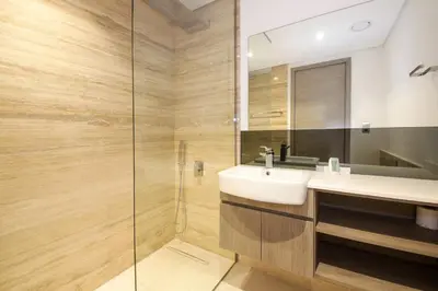 a bathroom with a sink and a shower at The Sterling By OMNIYAT Near To Dubai Mall in Dubai