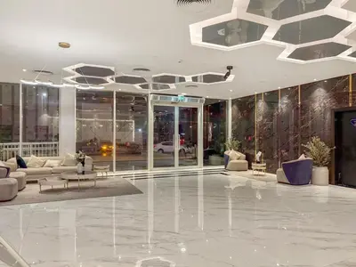 a lobby with couches and tables in a building at FIRST CLASS 1BR Luxe Living in Jewelz in Dubai