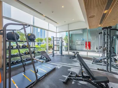 a gym with treadmills and machines in a building at 1BR at Vida -Steps from Dubai Mall & Burj Khalifa in Dubai