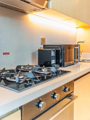 a stove top in a kitchen with a microwave at 1BR at Vida -Steps from Dubai Mall & Burj Khalifa in Dubai