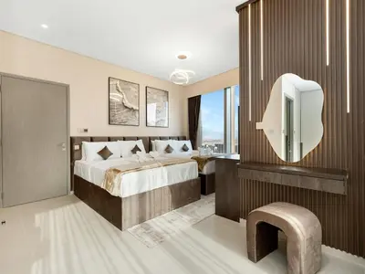 a bedroom with a bed and a tv in a room at Skyline View - 2 Balconies - Pool plus Gym - Sleeps 8 in Dubai