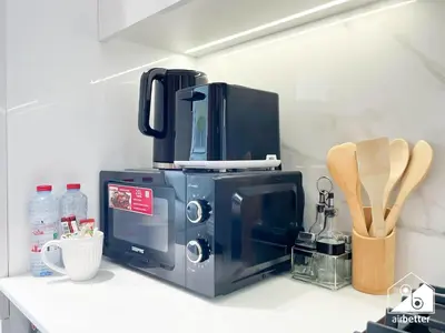 a microwave sitting on top of a kitchen counter at JVC Retreat with Pool & Balcony in Dubai