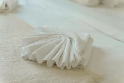 a pile of white towels sitting on the floor at 54th Floor Burj Khalifa&Mall Access Infinity Pool in Dubai