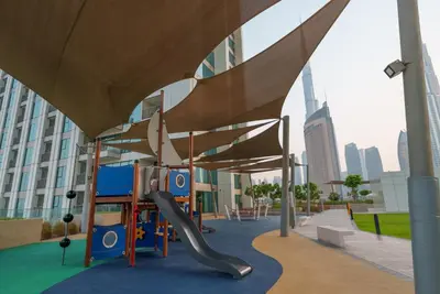 a playground in a city with a slide at 54th Floor Burj Khalifa&Mall Access Infinity Pool in Dubai