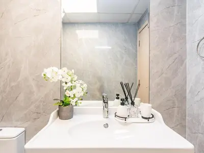 a bathroom with a white sink and a mirror at Spacious 1BR-Walk to Dubai Mall & Khalifa-Downtown Dubai in Dubai
