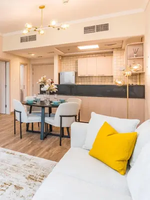 a living room with a white couch and a table at Spacious 1BR-Walk to Dubai Mall & Khalifa-Downtown Dubai in Dubai