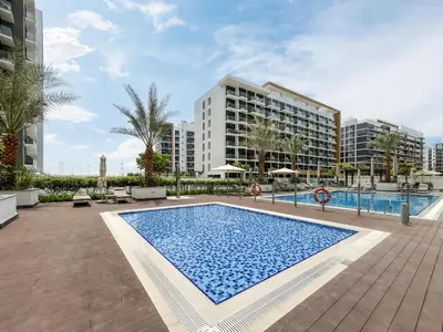 a swimming pool in front of a building at Urban Family Home minutes from Downtown in Dubai