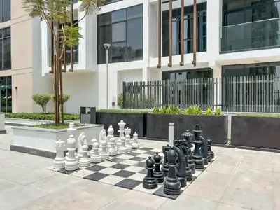 a chess board on a sidewalk in front of a building at Urban Family Home minutes from Downtown in Dubai