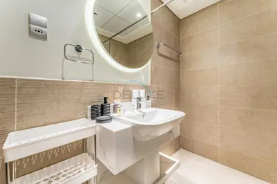 a bathroom with a sink and a mirror at Steps from Dubai Hills Park, Walk to Dubai Hills Mall, 15-Minute Drive to Burj Khalifa and Dubai Mall, Sway Residences, Dubai Hills by Deluxe Holiday Homes in Dubai