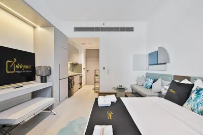a hotel room with a large bed and a couch at Posh Studio in MBR by Deleguest in Dubai