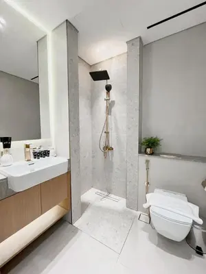 a bathroom with a sink and a toilet and a mirror at Lavish Studio Apt in Binghatti Azure - Pool & Gym in Dubai