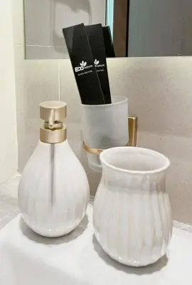 two white vases are sitting on a table at Lavish Studio Apt in Binghatti Azure - Pool & Gym in Dubai