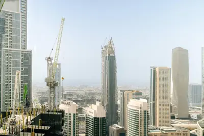 a view of a city with tall buildings and cranes at CitiHome Stylish 1BR Grande in Dubai