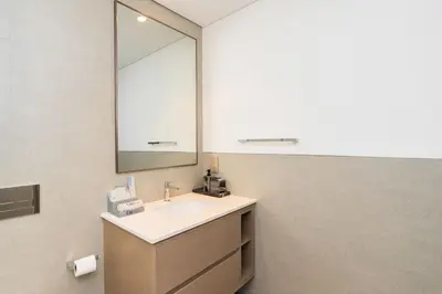 a bathroom with a sink and a mirror at CitiHome Stylish 1BR Grande in Dubai