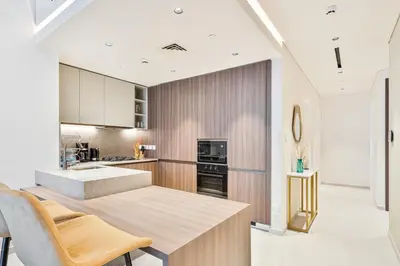 a kitchen with a table and chairs in a room at 2BR Homely Apartment in Arjan in Dubai