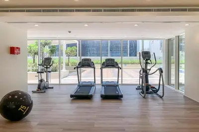 a gym with treadmills and ellipticals in a room at Stylish 2 BR Business Bay - Canal View - Gym and Pool in Dubai