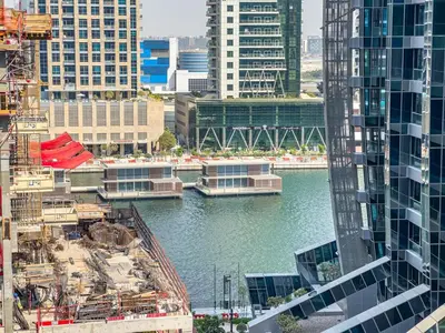 a view of a river in a city with buildings at Stylish 2 BR Business Bay - Canal View - Gym and Pool in Dubai