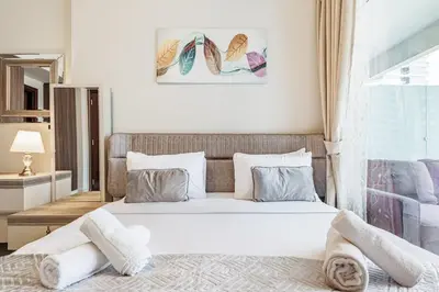 a bedroom with a large bed in a room at Stylish 2 BR Business Bay - Canal View - Gym and Pool in Dubai