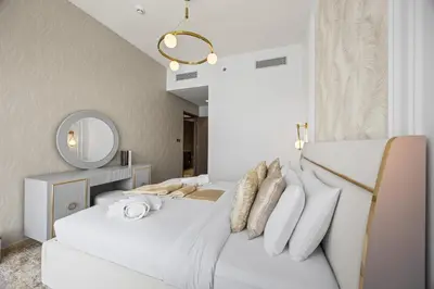 a white bedroom with two beds and a mirror at Burj Khalifa and Dubai Fountian Direct View - Luxury 2BR Flat - Downtown Dubai in Dubai