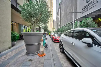 a car parked on the side of a street at Dunya Tower 1BR Heart of Dubai Downtown in Dubai